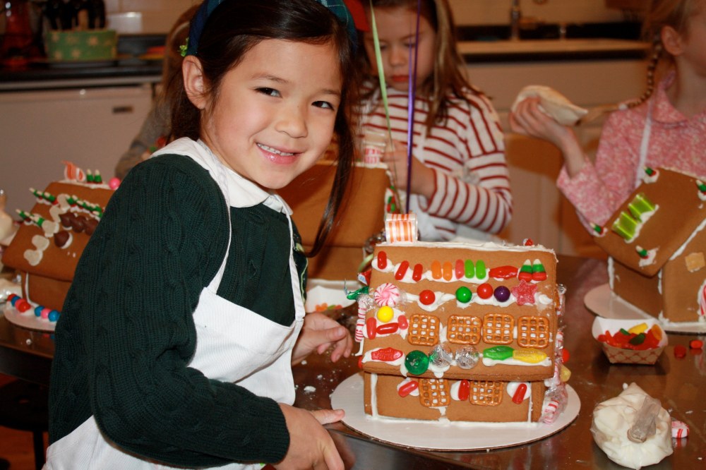 Gingerbread House a girl smiling with her gingerbread house