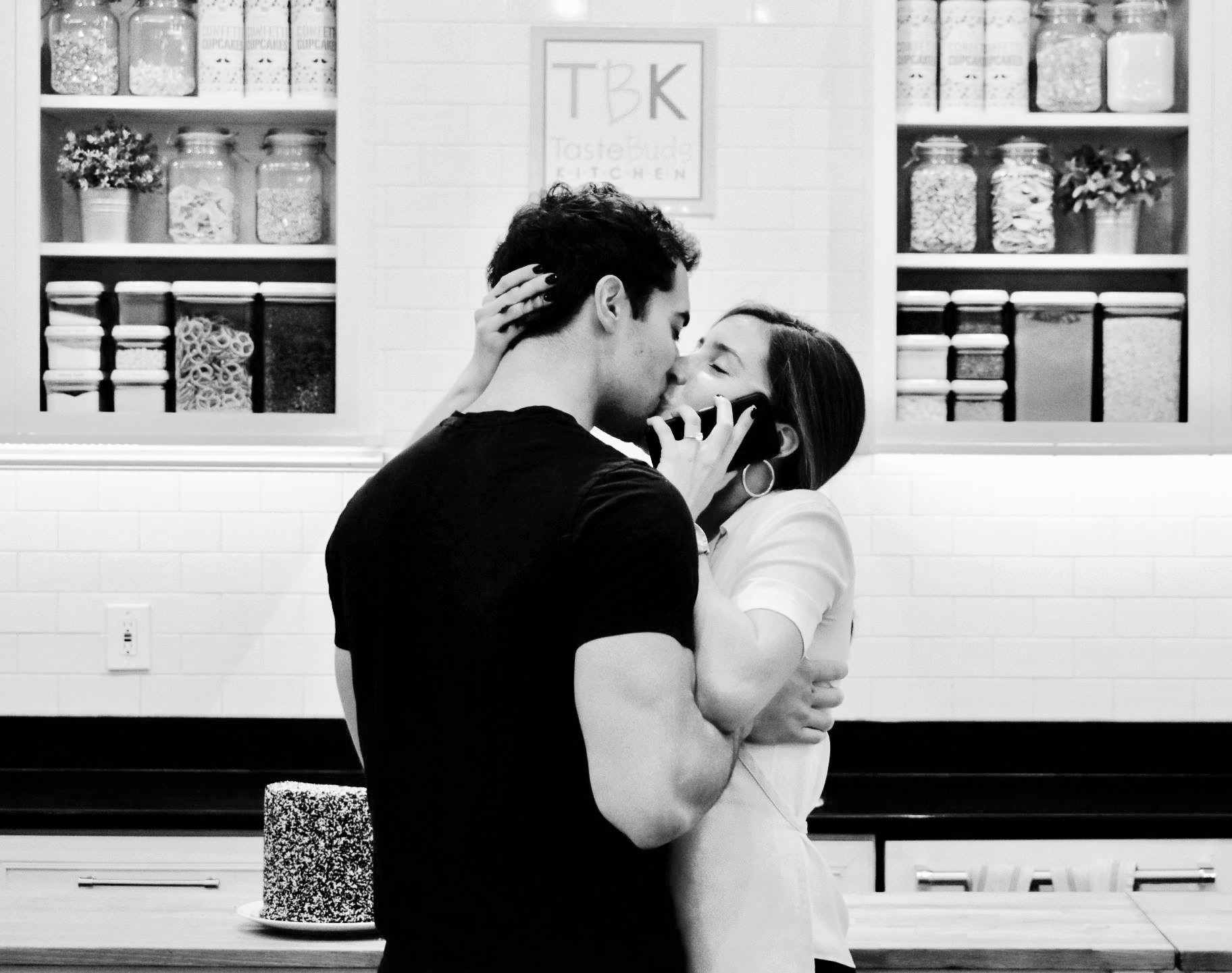 a couple kissing after getting engaged at a cooking class