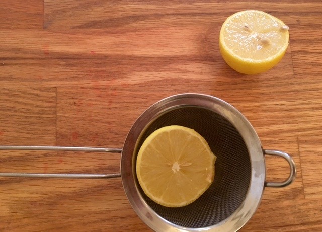 a cup of coffee sitting on top of a wooden table