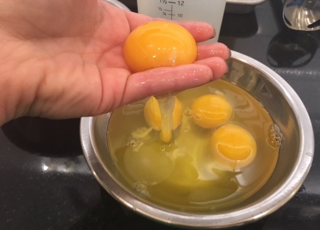 egg yolks and egg whites in a bowl