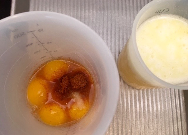 a bowl of soup sitting next to a cup of coffee