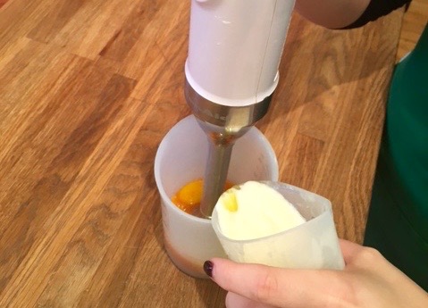 pour melted butter into egg yolk and cayenne pepper mix