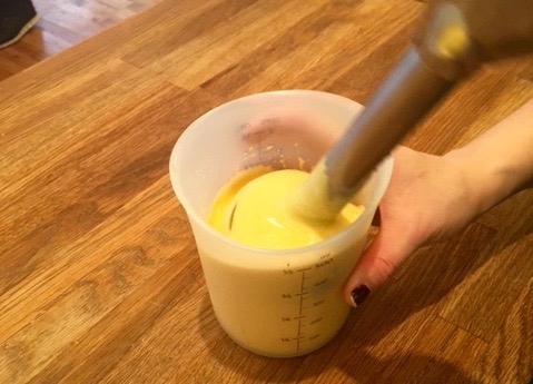 a cup of coffee sitting on top of a wooden table