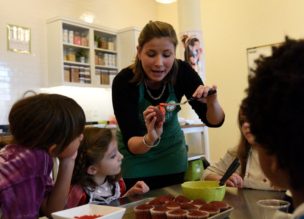 a man and a woman standing in front of a cake