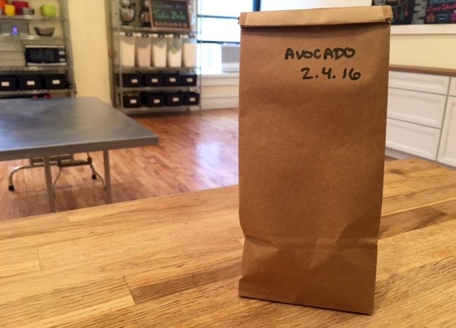 brown bag with an avocado in it