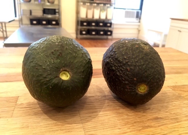 comparing two avocados