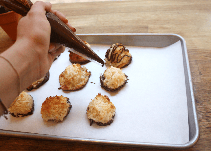 a person holding a plate of food on a table