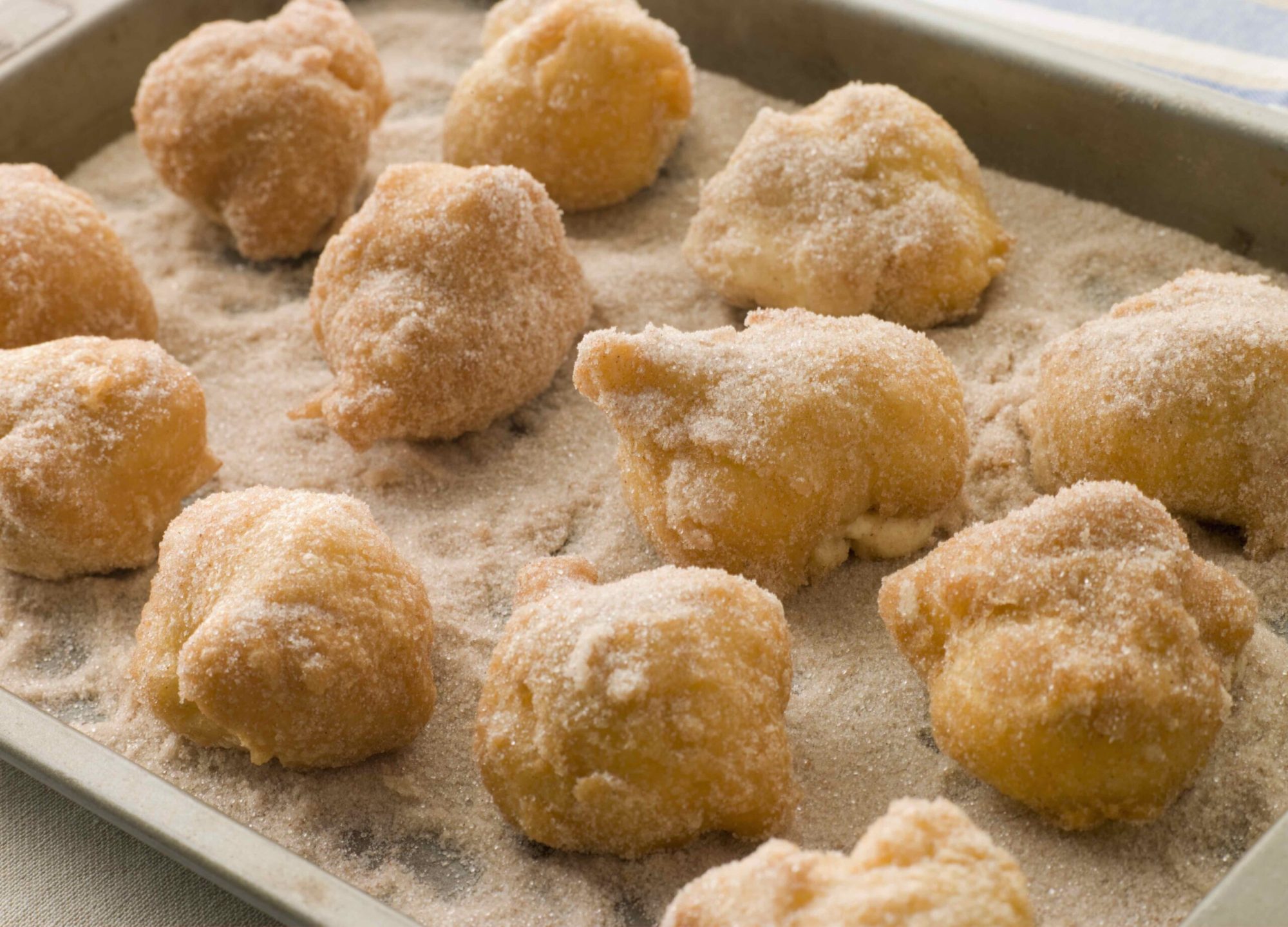Lemon and Cinnamon Souffle Fritters churro bites in cinnamon sugar