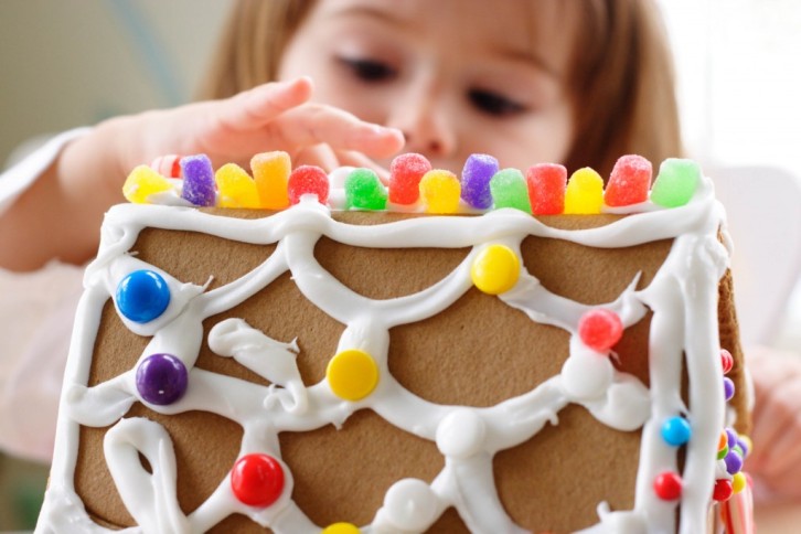 Gingerbread-Decorating-Class-e1418281708670 a close up of a baby with a birthday cake