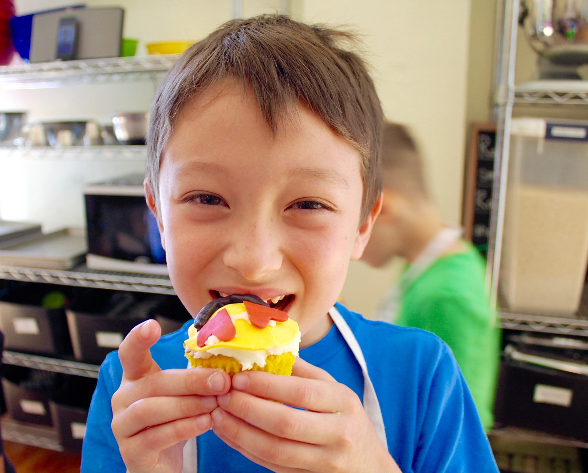 Taste-Buds-Kitchen-Emoji-1-1 a little boy eating his cupcake