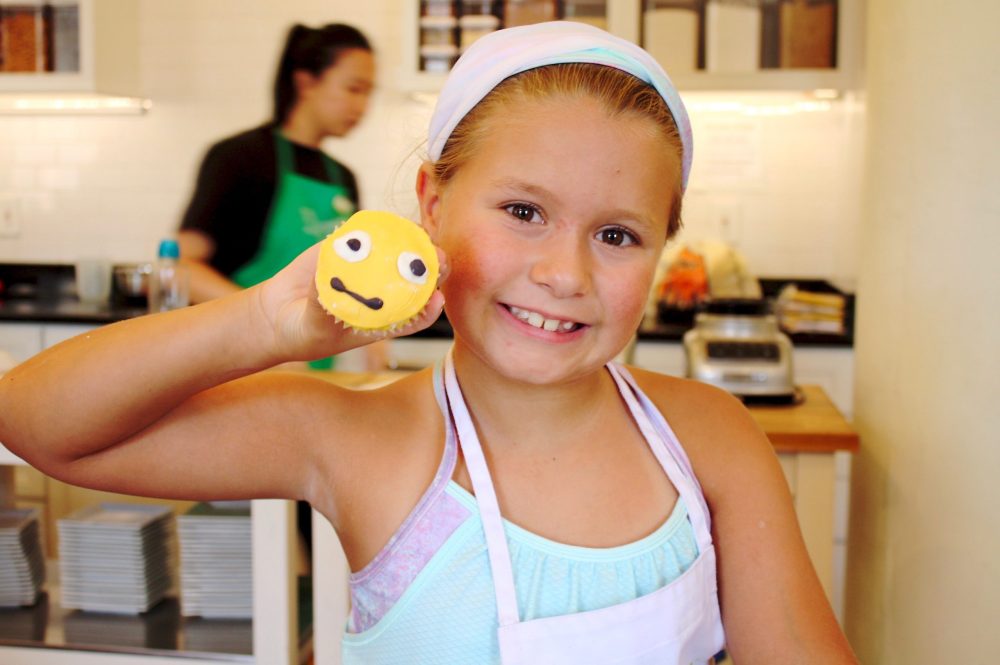 a little girl smiling at the camera