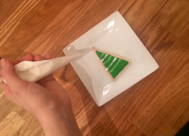 a hand holding a piece of wood