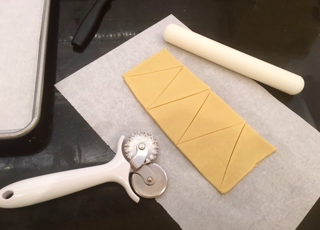 cut triangles into sugar cookie dough