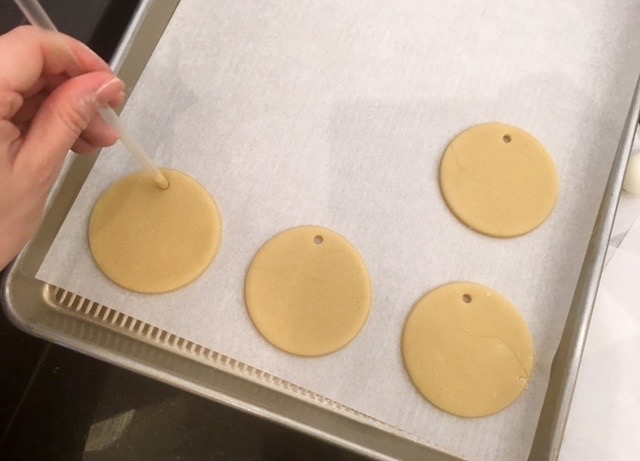 place holes on top of circle cookie dough to make ornaments