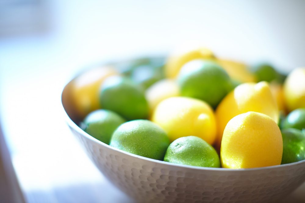limes and lemons in a wooden bowl