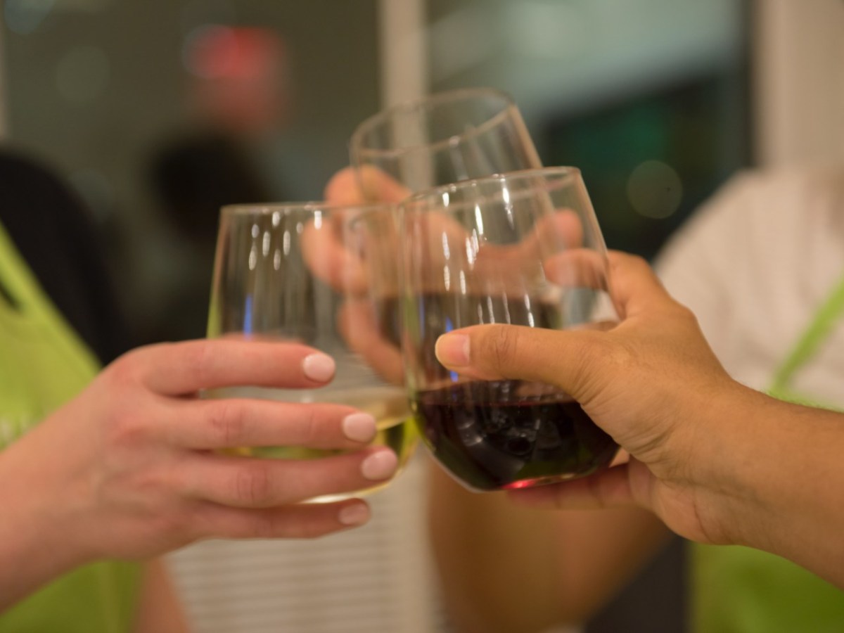 three wine glasses clinking in a toast