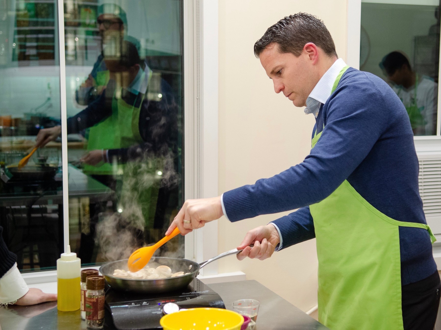 a man sautéing food in a hot pan