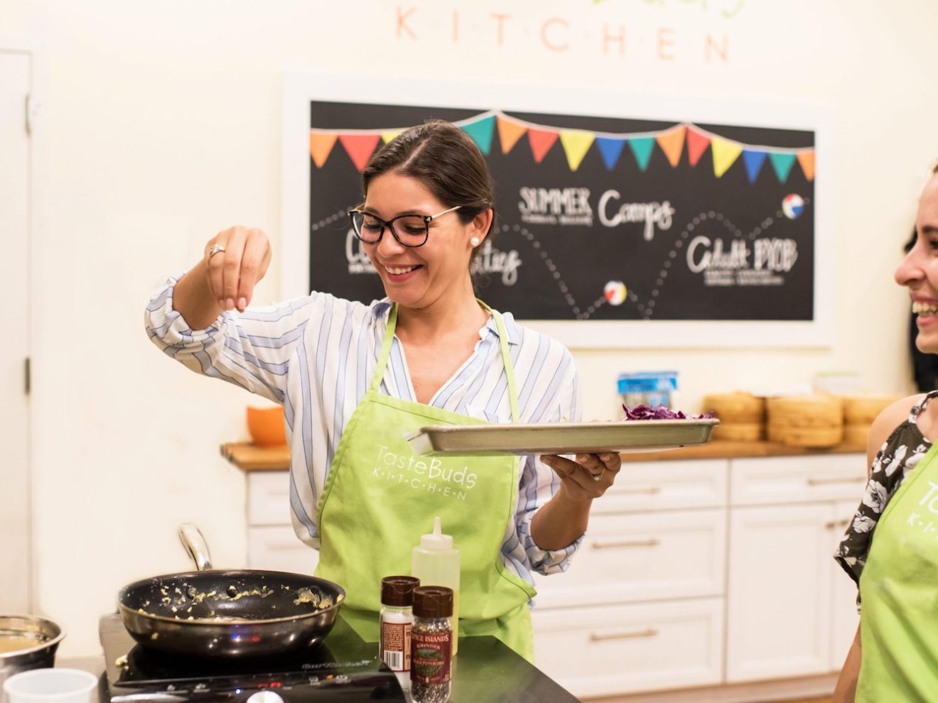 a woman sprinkling salt into pan