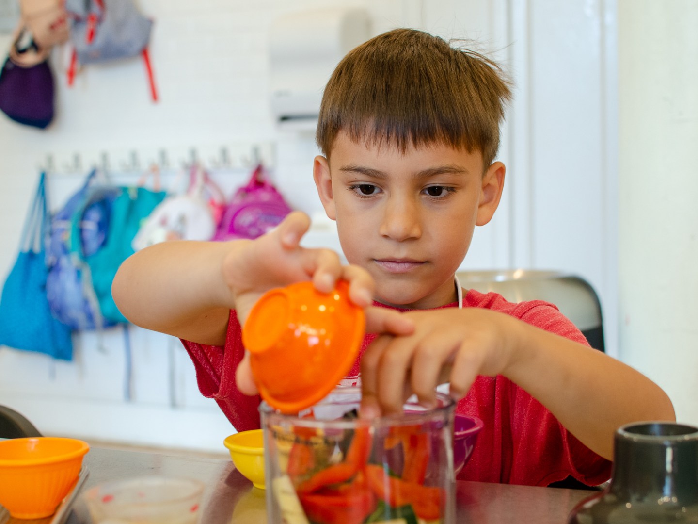 a boy using a food measuring cup