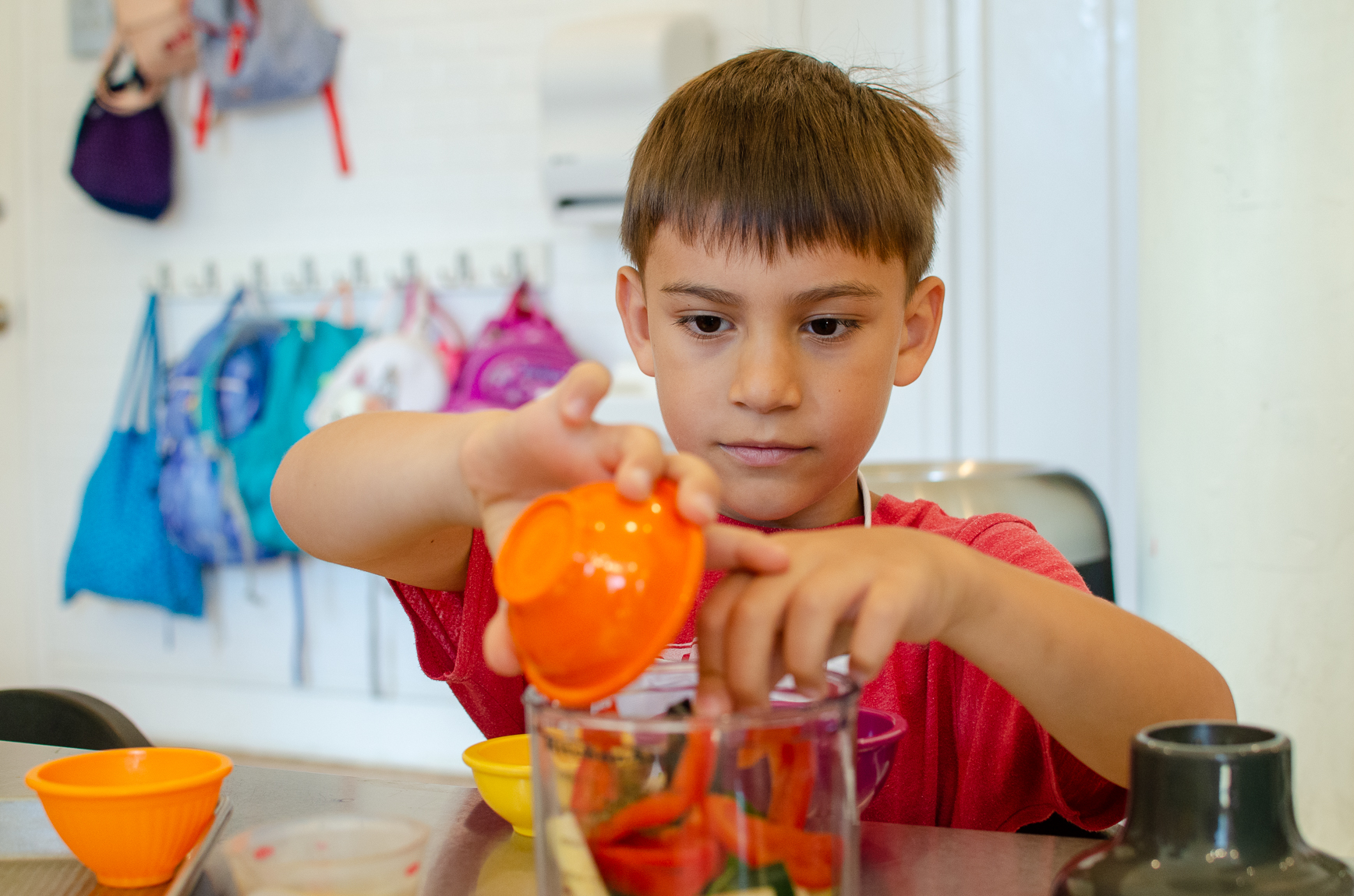 a boy using a food measuring cup