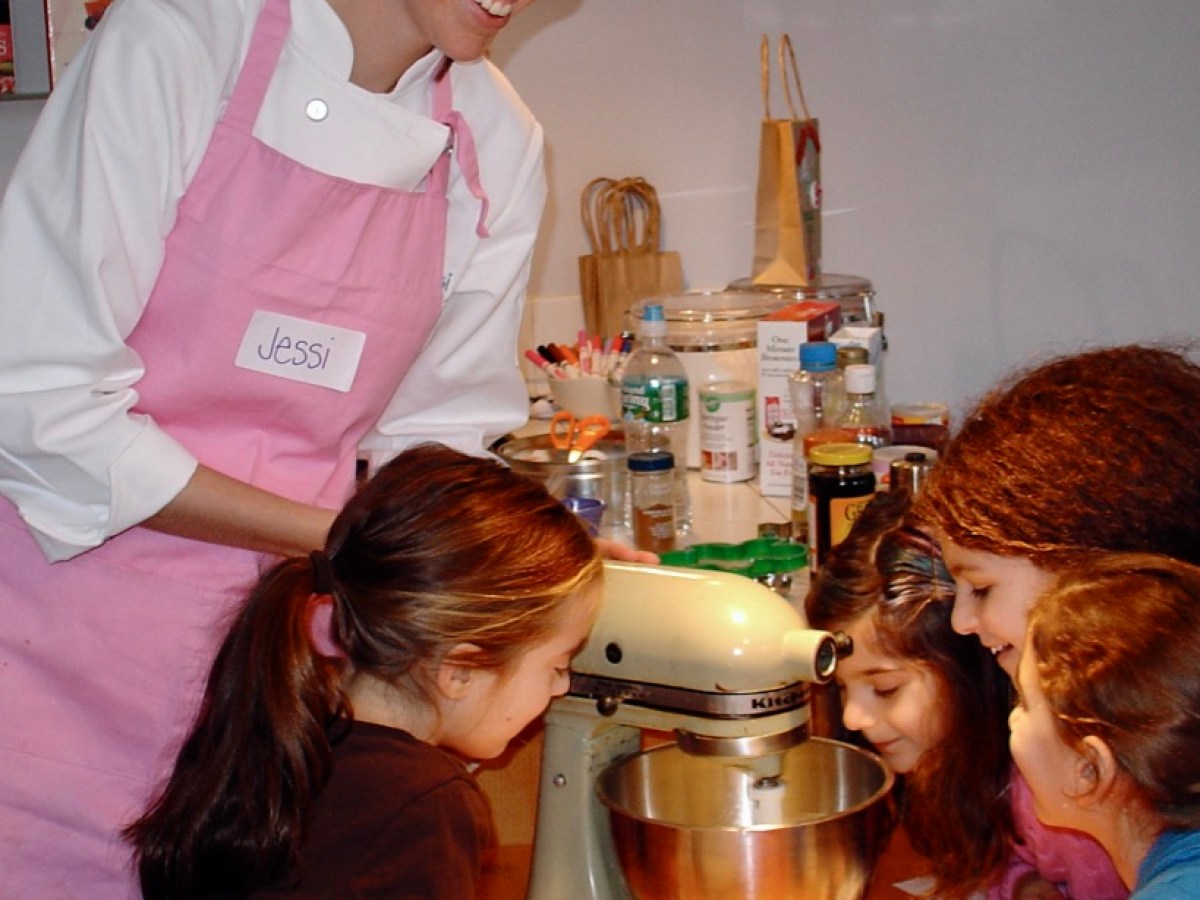 a woman preparing food in a kitchen