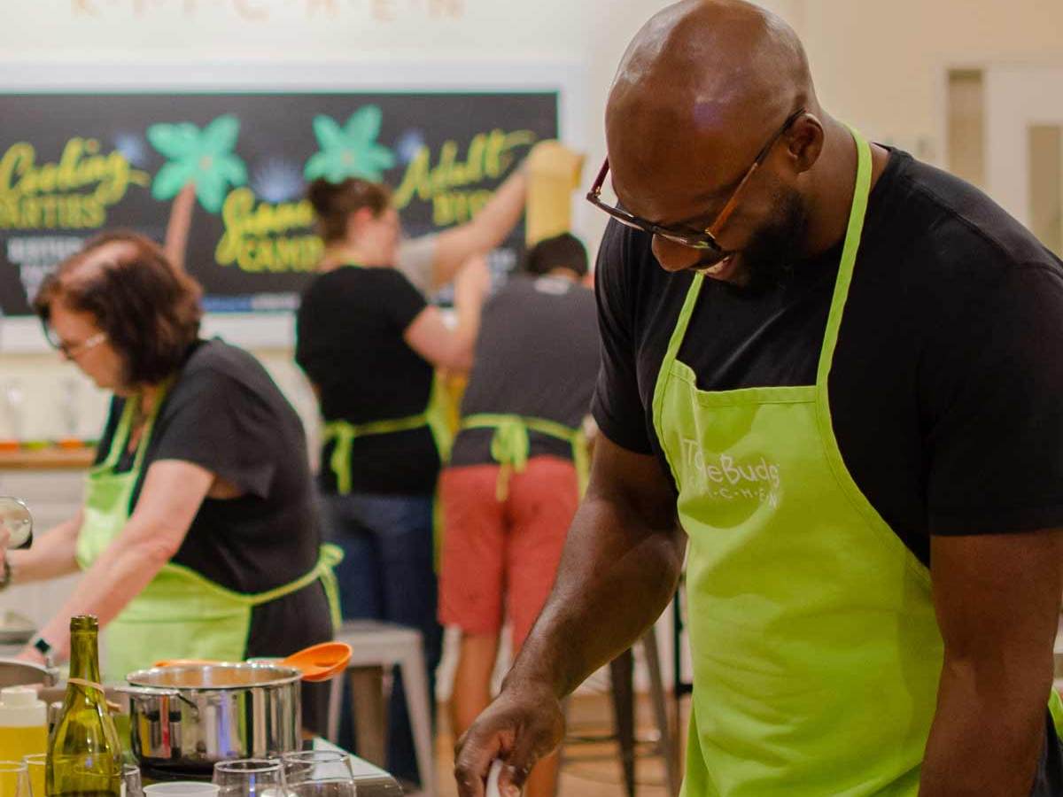 a man cutting food at a byob event