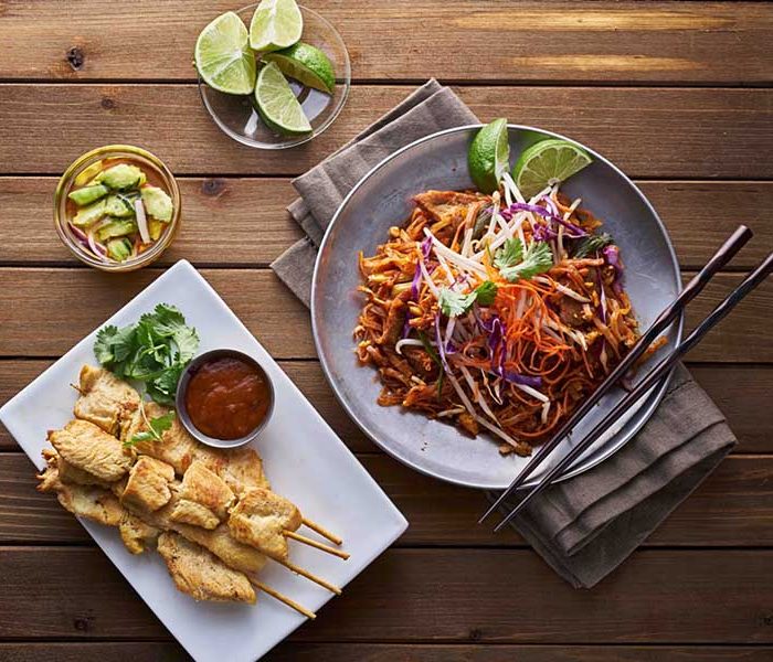 a plate of food sitting on top of a wooden table