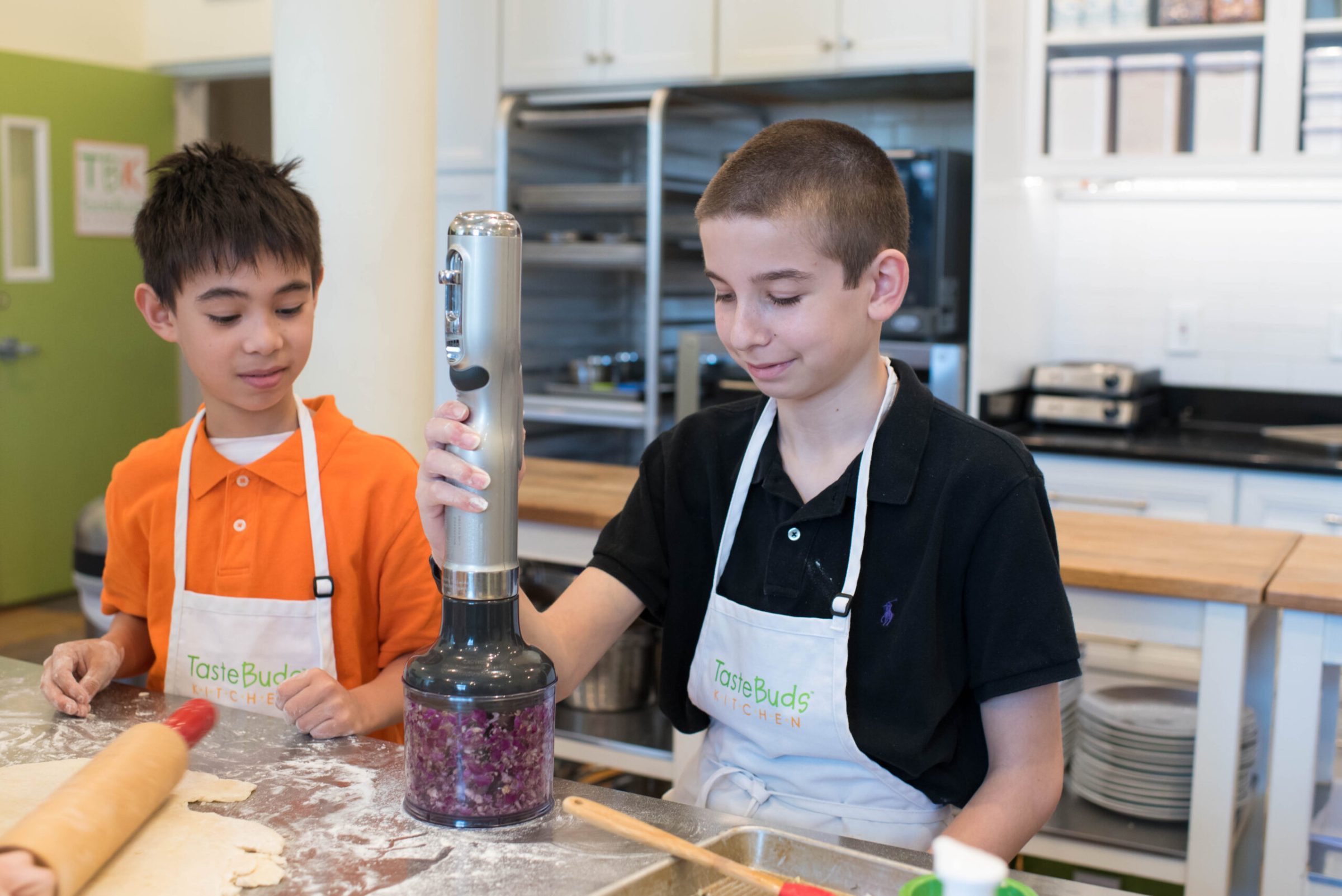 a young boy using a food processor