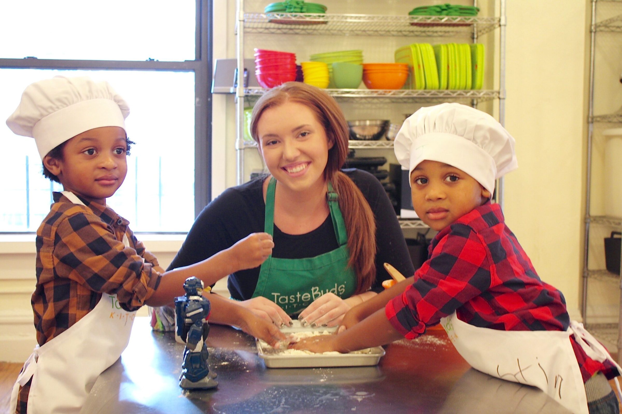 two young boys and their baking teacher preparing dough