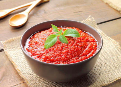 Taste-Buds-Kitchen-Tomato-Sauce a bowl of food sitting on top of a wooden table