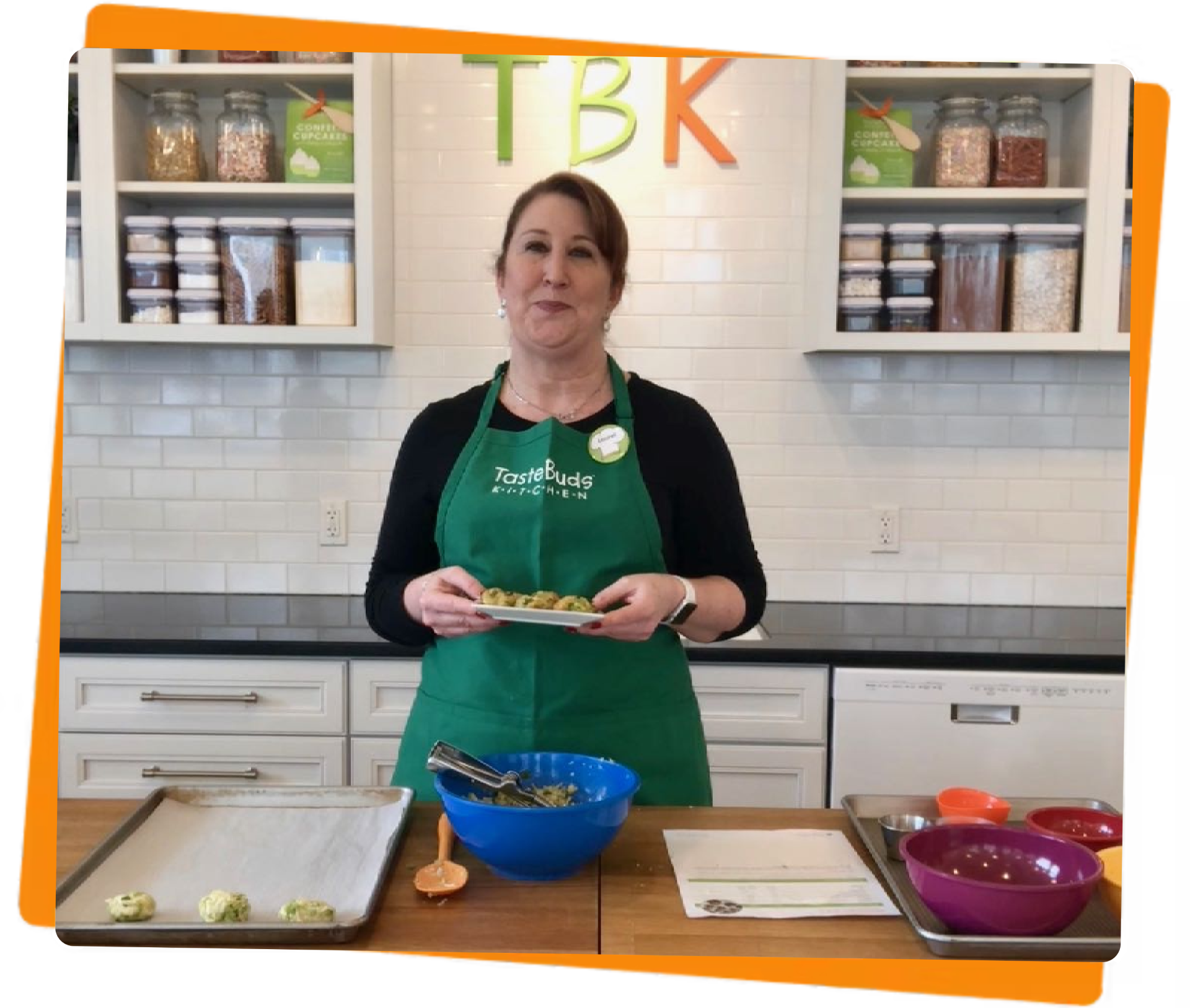 Women standing with a plate of baked goods