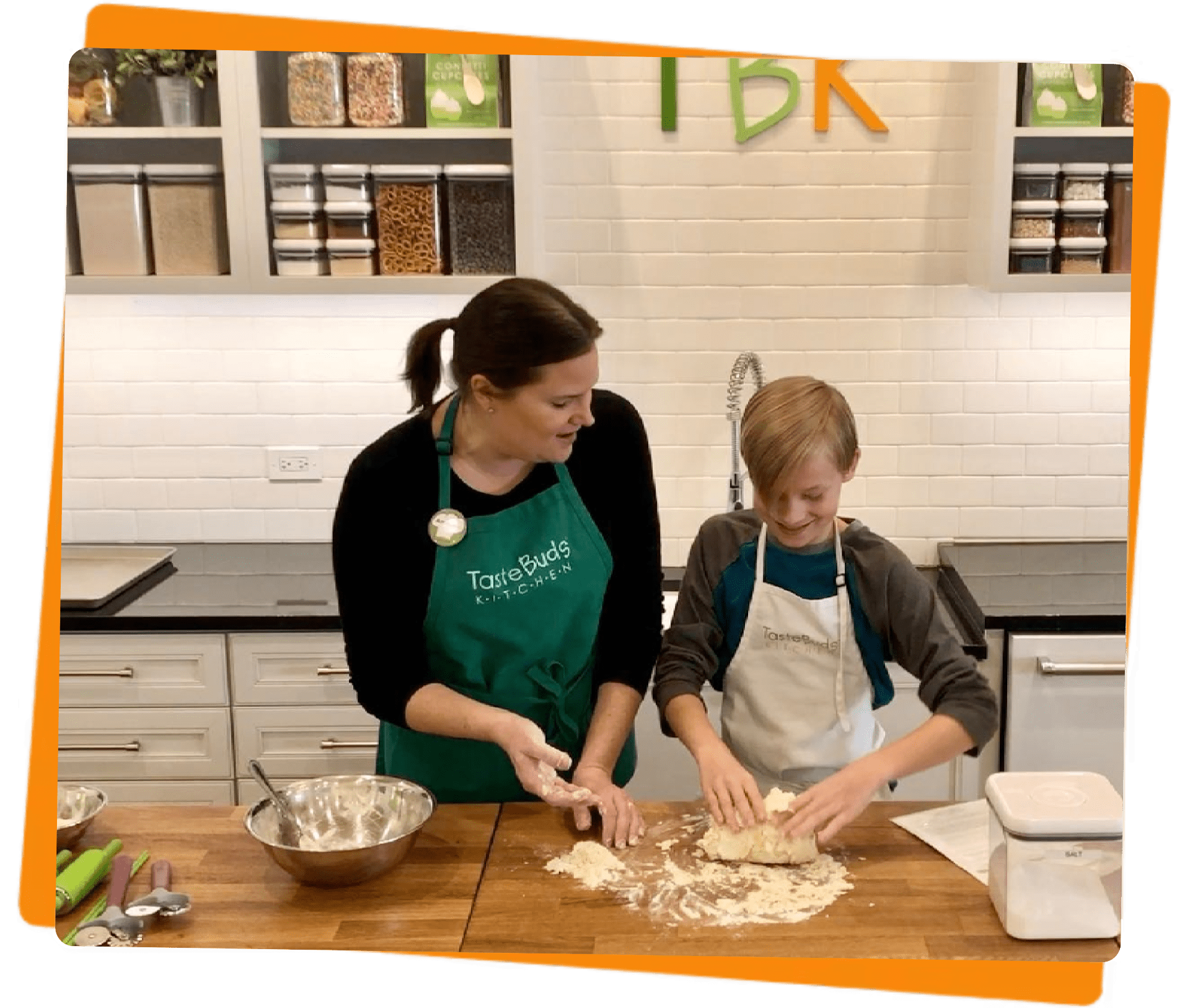 Women and boy rolling dough