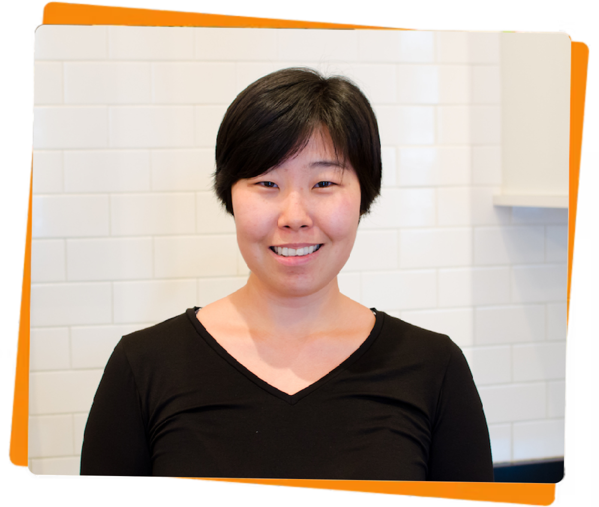 2(6) a woman standing in front of a window posing for the camera